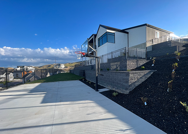 backyard view of a retaining wall for a house on a hill